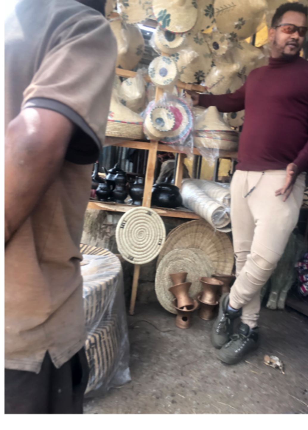 Shop visited as a potential distribution point for the Noah stove, showing existing household goods on shelves
