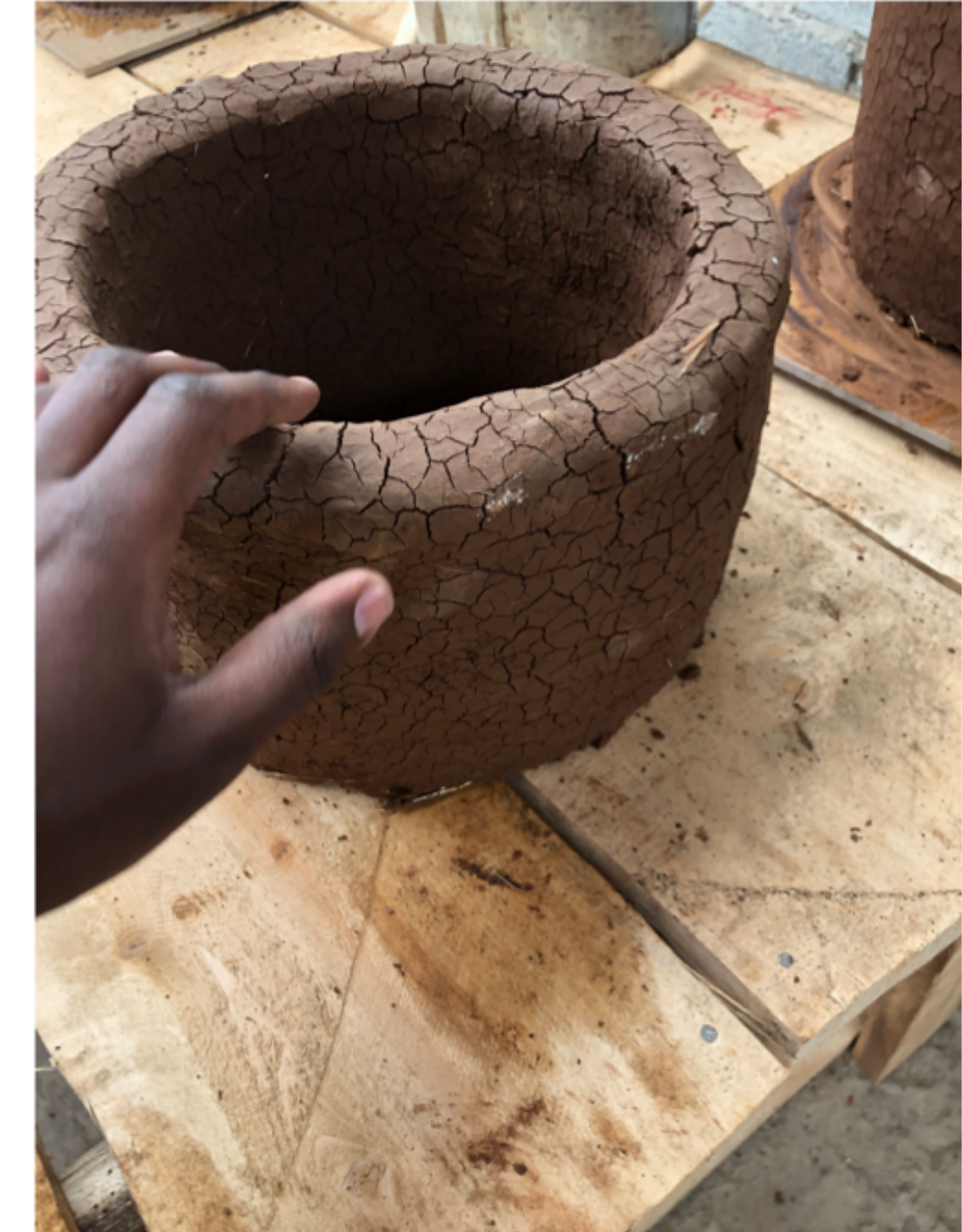 Finished hollow clay test stove body showing visible surface cracking