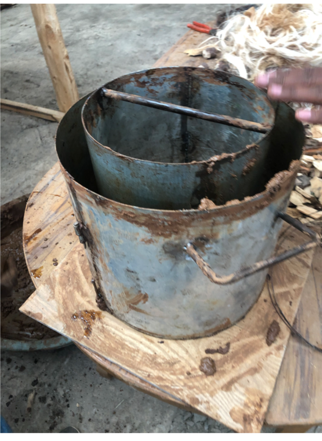 Finished metal can liner mounted on a wooden base for the stove's gasifier chamber